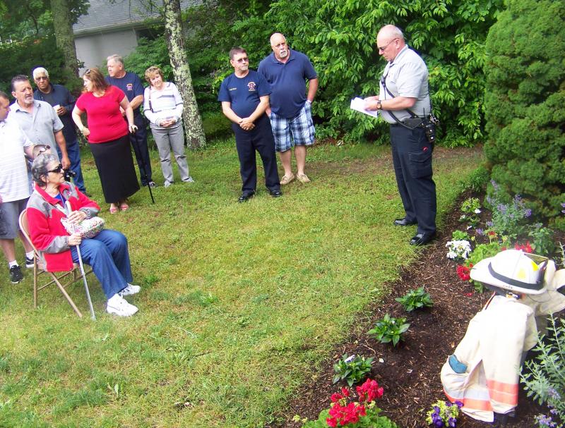 Marion Fire Chief Tom Joyce, right, speaks to Nye Sr.'s friends and family on Saturday. BY MATTHEW BERNAT